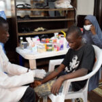 OSCCF NURSE TREATING AN ORPHAN